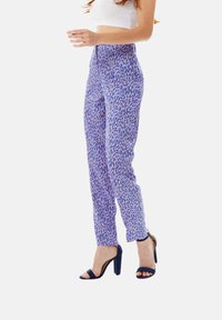 Purple patterned trousers with a slim fit and tapered leg. Features a high waist and a subtle abstract design in pink and blue tones.