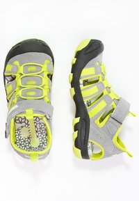 Gray sandals with bright yellow accents, featuring a breathable textile upper, adjustable strap, and textured rubber sole with a patterned insole.
