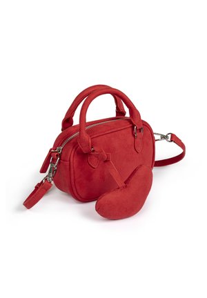 Petit sac à main rouge en daim avec double poignée, fermeture éclair, bandoulière amovible et pochette en forme de cœur attachée.