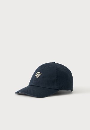 Dunkelblaue Baseballkappe mit gebogenem Schirm und einem kleinen bestickten lächelnden Gesicht mit Kappe auf dem Frontpanel.