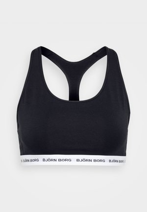 Black sports bra with a racerback design, made of stretch fabric, featuring a white branded elastic band at the bottom. Smooth texture.