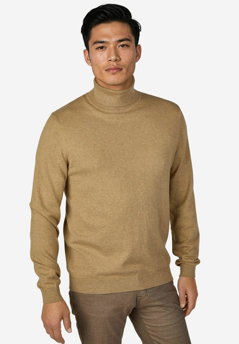 Beiger Rollkragenpullover aus weichem Strickmaterial. Mit langen Ärmeln und figurbetontem Schnitt sowie gerippten Details am Hals- und Ärmelabschluss.