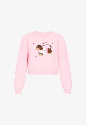 Różowa skrócona bluza z teksturowanym brązowym psem w stroju w kropki. Zabawne napisy, gwiazdy i balony w żywych kolorach.