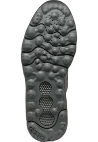 Semelle de chaussure en caoutchouc gris présentant des motifs texturés de différentes tailles, comprenant des bosses arrondies et des rainures pour la traction et le confort.