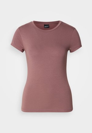 T-skjorte med korte ermer, tettsittende i rosafarge, laget av mykt og elastisk stoff. Har rund hals og jevn tekstur uten dekorasjoner.