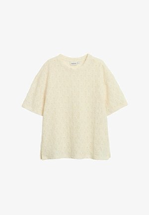 Oversized T-shirt i cremefarve med korte ærmer, tekstureret stof med et diskret løvmønster og sideslids for øget komfort.