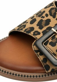 Leopard print slide sandal with a wide strap. Brown leather footbed, metallic gold buckle, and rounded shape with black bead accents.