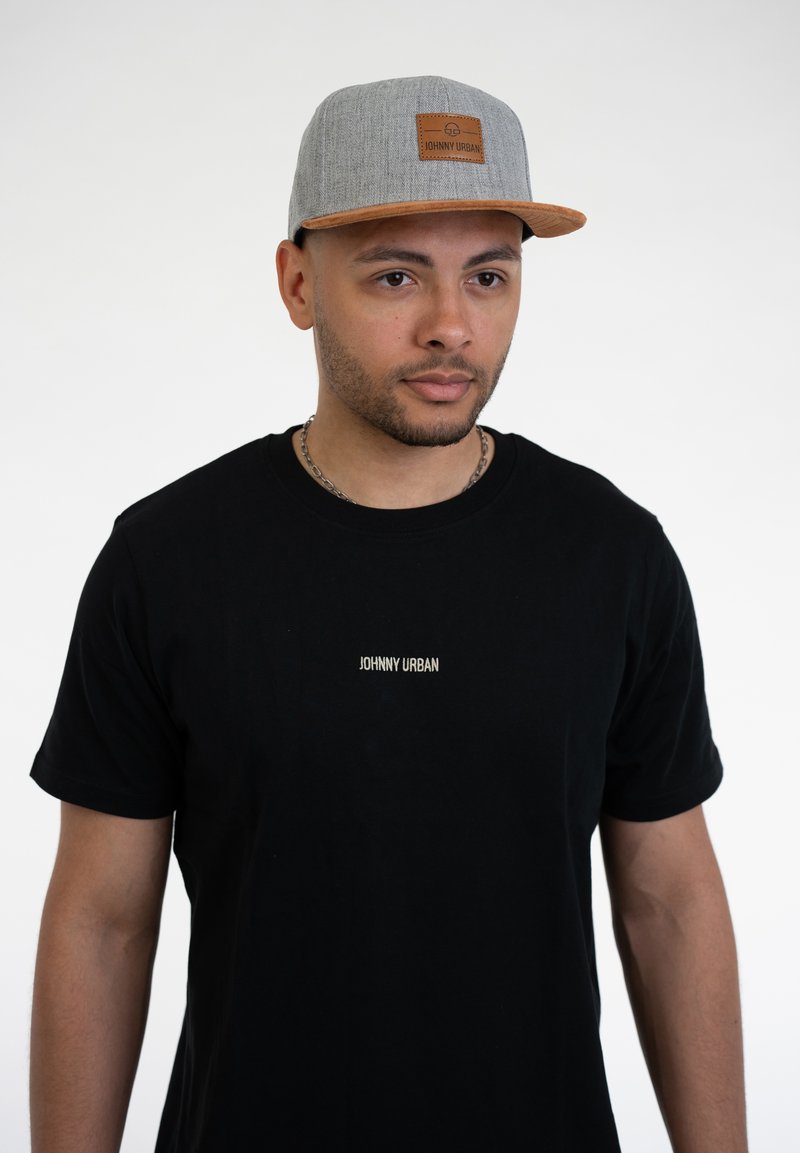 Black crew neck t-shirt with "JOHNNY URBAN" logo in white. Gray cap with a textured fabric and leather patch, contrasting brim.