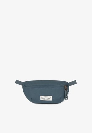Eastpak fanny pack in dark blue fabric, oval shape with a zipper closure, adjustable strap, and a logo patch on the front.