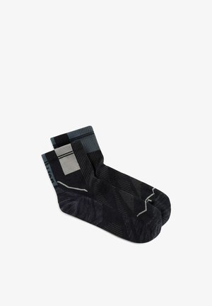 Pair of black and gray ankle socks with geometric patterns and varying shades of gray on a white background.
