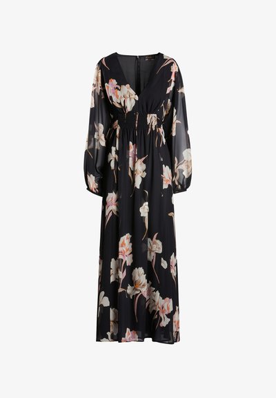 Musta kukkamekko syvällä V-pääntiellä, pitkät läpinäkyvät hihat, smockattu vyötärö ja suuret vaaleanpunaiset ja valkoiset kukkakuviot ympäriinsä.