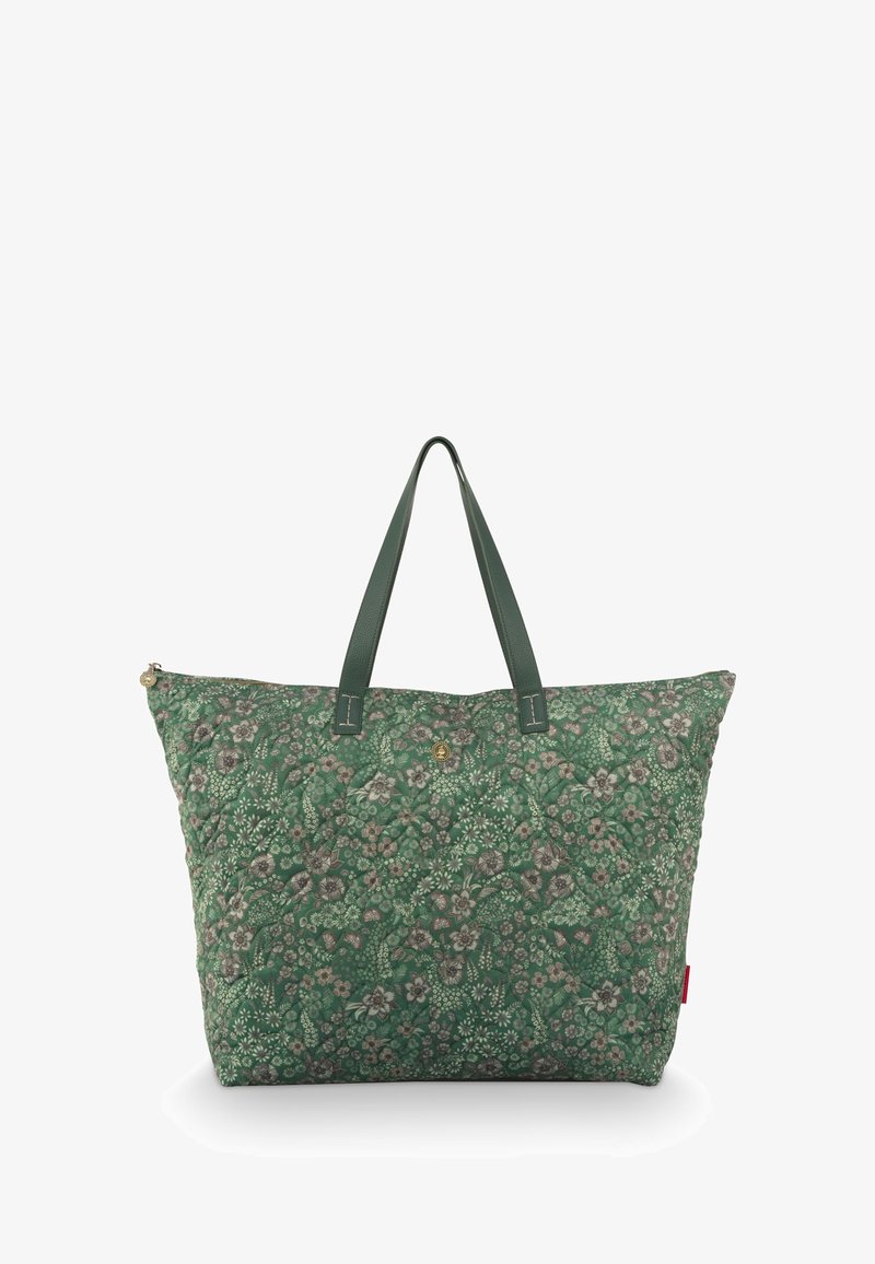 Groene tas met bloemenpatroon, gemaakt van geborduurd stof. Voorzien van twee groene leren handvatten en een ritssluiting.