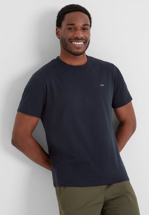 Navy blue short-sleeve t-shirt made of cotton. Features a round neckline and small logo on the chest. Smooth texture, casual fit.