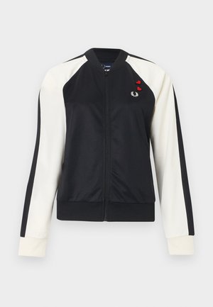 Giacca con zip bianco e nero con maniche lunghe, polsini a coste e piccoli loghi a cuore rosso e alloro sul petto sinistro.