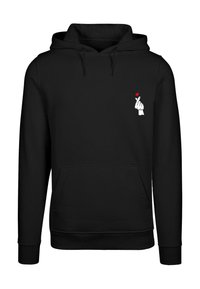 Black hoodie made of soft fabric, featuring a front kangaroo pocket and a white graphic of a hand with a red heart on the chest.