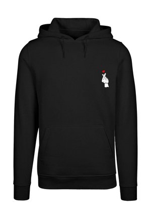 Fekete kapucnis pulóver puha anyagból, elülső kenguru zsebbel és egy fehér grafikával, ami egy kezet ábrázol piros szívvel a mellrészen.