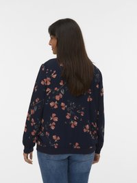 Floral bomber jacket in navy blue with pink and green floral patterns, long sleeves, ribbed cuffs, and waist. Viewed from the back.