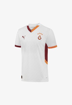 Weißes Fußballtrikot mit roten und orangefarbenen Akzenten. Es hat einen V-Ausschnitt, ein Vereinslogo und eine wellenförmige Musterstruktur im gesamten Stoff.