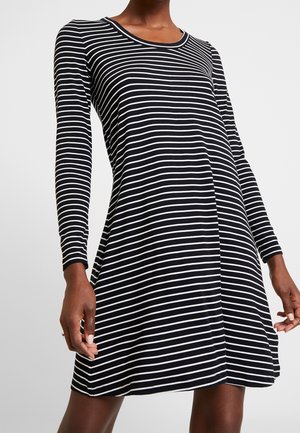 Robe à manches longues rayée noir et blanc avec un col rond, une coupe décontractée et un ourlet évasé, fabriquée en tissu doux et extensible.