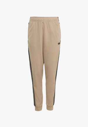 Pantalones deportivos beige con cintura elástica, franjas laterales negras y detalles de puños en los tobillos. Confeccionados con una tela suave y ligera.