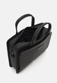 Porte-documents en cuir noir avec deux poignées supérieures, intérieur rembourré et fermeture éclair. Présente une finition texturée et une étiquette de marque.