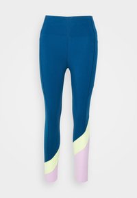 Vysoké legíny v tmavě modré barvě, s geometrickým barevným blokováním v jemně žluté a světle růžové na dolní části nohavic, vyrobené z elastického materiálu.