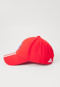 Red baseball cap with a curved visor, embroidered logo on the front, three white stripes on the brim, and white three-stripe accent on the side.