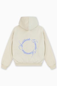 Krémová mikina s kapucňou, ktorá má na zadnej strane okrúhly modrý textový dizajn, mäkkú štruktúru a elastický pás.