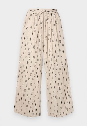 Pantalons larges beige avec une taille à nouer, ornés d'un motif de losanges noirs. Fabriqu�és dans un tissu léger pour plus de confort.