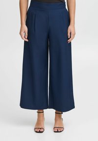 Navy wide-leg pants with front pleats, made of smooth fabric. Features a fitted waistband and cropped length above the ankle.
