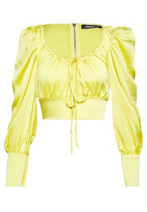 Yellow satin cropped blouse with puffed long sleeves, gathered neckline with central drawstring, wide fitted waistband, and back zipper closure.