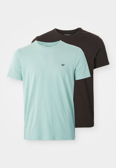 Two plain crew neck short-sleeve t-shirts, one light blue and one dark brown, each with a small logo on the left chest.