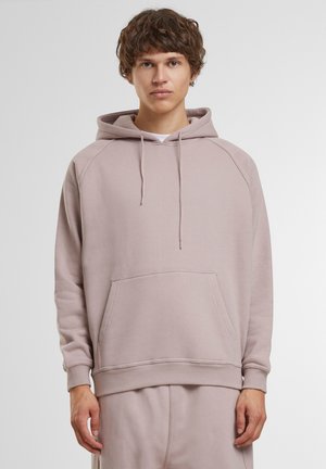 Hooded sweatshirt in light pink. Features a kangaroo pocket, ribbed cuffs, and hem. Made of soft material with a relaxed fit.