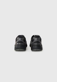 Black athletic shoes with a mesh and synthetic upper, featuring a padded collar, textured heel accents, and a durable rubber outsole.