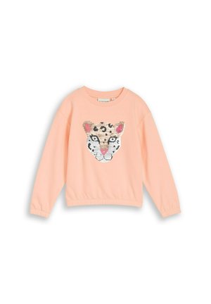 Jasnoróżowa bluza z długim rękawem z cekinowym wzorem twarzy lamparta w kolorach beżowym, białym, czarnym i różowym na środku przodu.