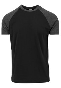 Černé tričko s krátkým rukávem a šedými raglánovými rukávy, vyrobené z měkké bavlny, s kulatým výstřihem a minimalistickým designem.