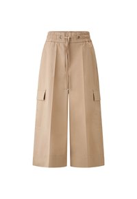 Beige cargo kalhoty širokého střihu s elastickým páskem, stahováním na šňůrku a dvěma bočními kapsami; hladká látka s volným střihem.