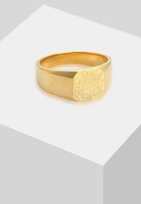 Gold ring with a textured, hexagonal top and a smooth band. Features a polished finish, emphasizing shape and defined edges.