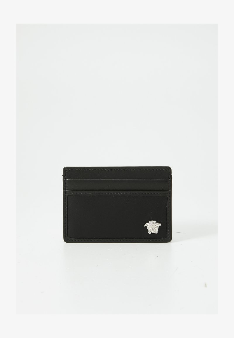 Black leather cardholder featuring a textured finish, multiple card slots, and a silver Medusa emblem accent on the front.
