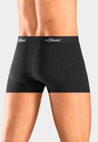 Black cotton boxer shorts featuring a wide waistband with "s.Oliver" logo, smooth texture, and fitted design.