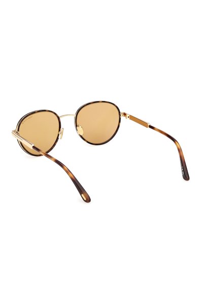 Runde Schildpatt-Sonnenbrille mit goldfarbenem Metallsteg und braun getönten Gläsern, liegend auf einer weißen Fläche.