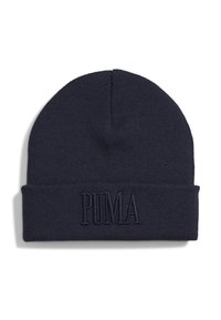 Navy sininen neulepipo, jossa on käänne, jossa on kohokuvioitu "PUMA"-logo samassa värissä. Pehmeä tekstuuri, pyöreä yläosa.