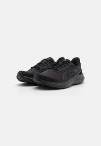 Black athletic shoes with a mesh upper, textured fabric, and reinforced toe. Features a cushioned sole and sleek design accents.