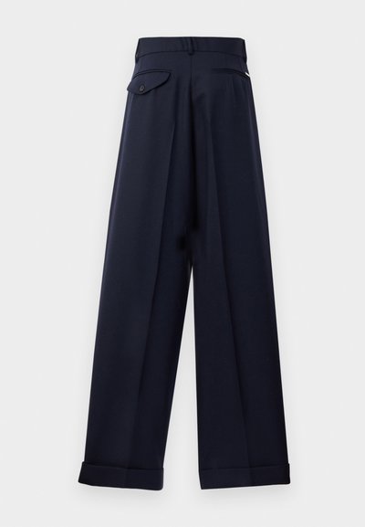 Navy wide-leg trousers with a crisp fabric, featuring back pockets, pleats, and turned-up cuffs for a structured look.