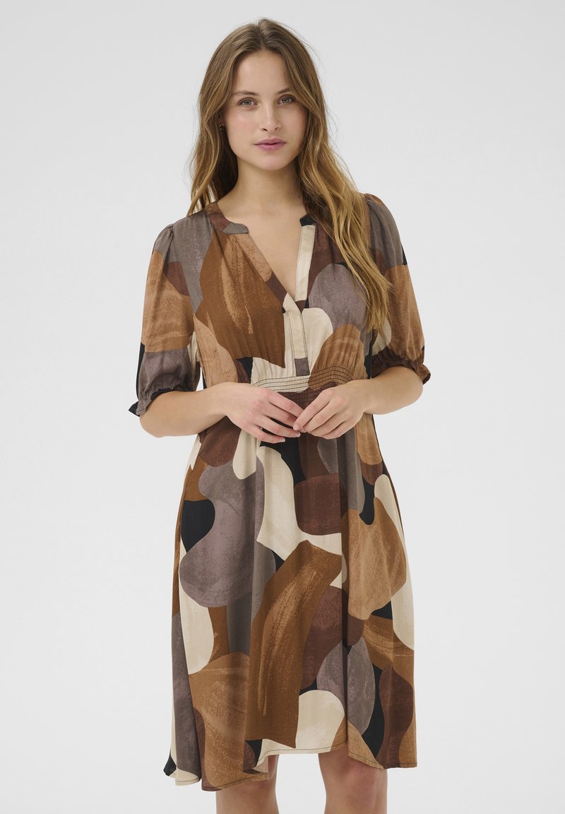 Brown and cream patterned dress with a V-neckline, short puff sleeves, and a fitted waist. Lightweight fabric with a smooth texture.