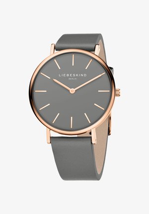 Grå silikonerem ur med en rund grå urskive, roseguld visere og minimalistiske timemarkører. Mærkenavnet "LIEBESKIND BERLIN" vises.