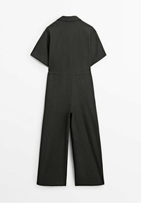 Dark green short-sleeve jumpsuit with a collared neckline, waist seam, and wide leg design. Fabric appears smooth and tailored.
