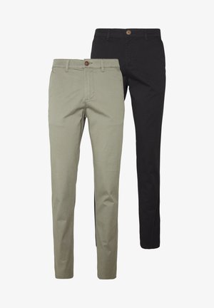 Two pairs of slim-fit pants: one in light beige cotton with a button detail, the other in solid black cotton, both with side pockets.