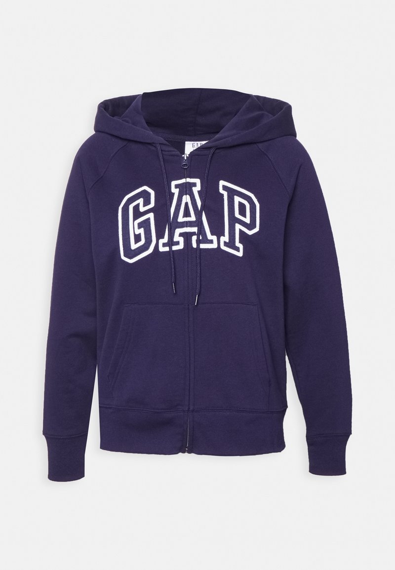 Sweat à capuche zippé bleu marine avec poches avant, capuche à cordon et logo "GAP" brodé en blanc sur la poitrine.