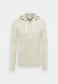 Felpa con zip color beige chiaro realizzata in morbido tessuto a maglia. Caratterizzata da un cappuccio grigio a contrasto, tasche a marsupio e cordini.